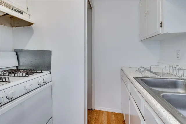 a kitchen with a stove and a sink