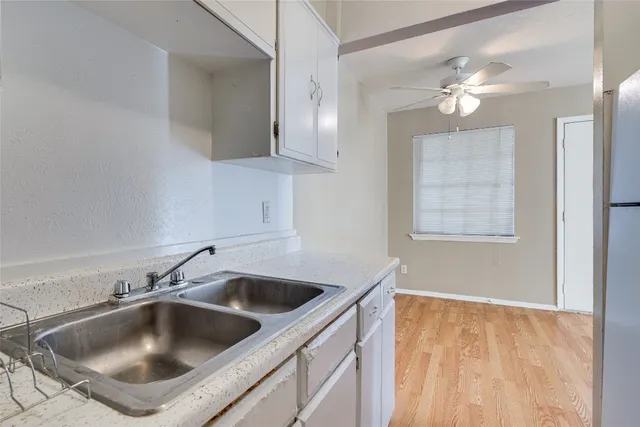 a kitchen with a sink and chandelier