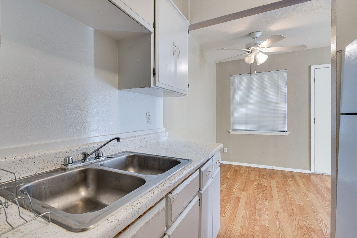307 East 31st Street, Unit 205 Austin, TX 78705 - Photo 15 of 35 a kitchen with a sink and chandelier
