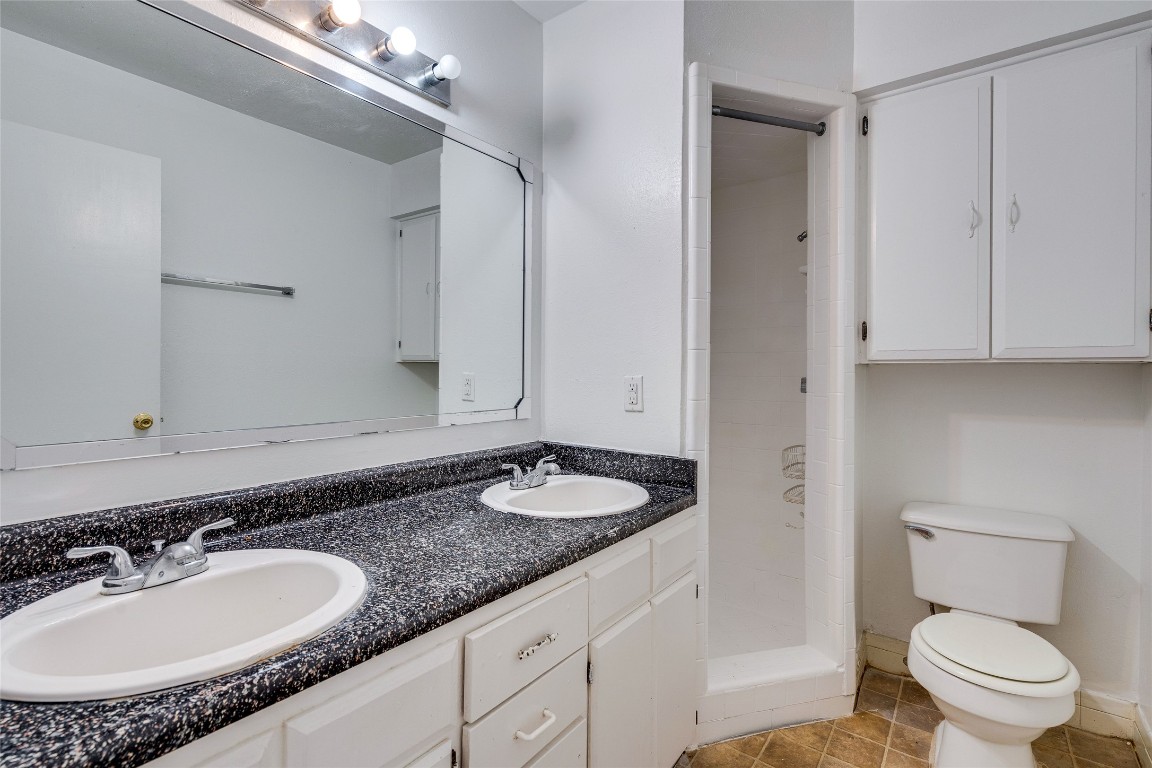 307 East 31st Street, Unit 205 Austin, TX 78705 - Photo 17 of 35 a bathroom with a granite countertop sink and a mirror