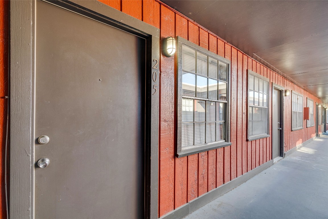 307 East 31st Street, Unit 205 Austin, TX 78705 - Photo 28 of 35 Entrance to property with board and batten siding and a porch