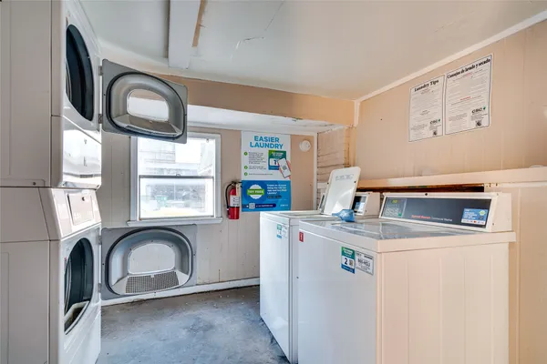 a view of a kitchen with fridge and window