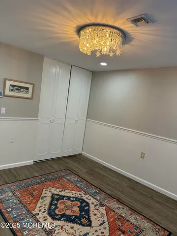 a view of a kitchen with a sink and wooden floor