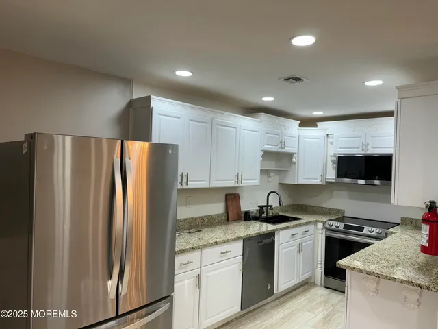 a stove top oven sitting inside of a kitchen