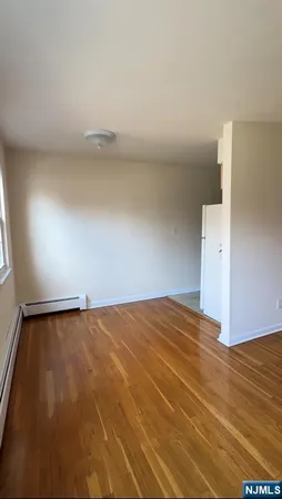 a view of a room with an empty space and a window