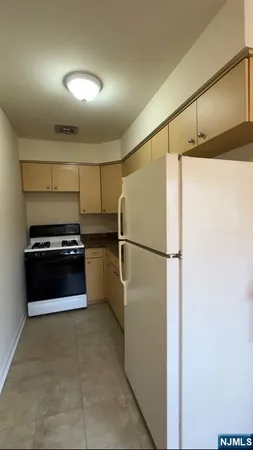 a kitchen with a refrigerator and a stove