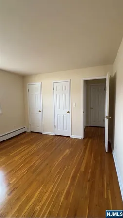 a view of an empty room and wooden floor