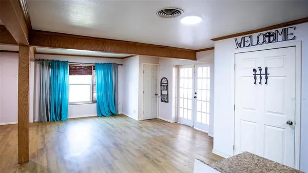 a view of a hallway with wooden floor