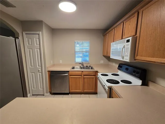 a kitchen with granite countertop a sink cabinets and a window