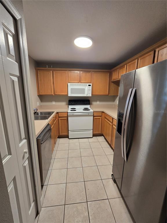 236 Castlekeeper Place Valrico, FL 33594 - Photo 3 of 14 a kitchen with granite countertop stainless steel appliances a sink and a refrigerator