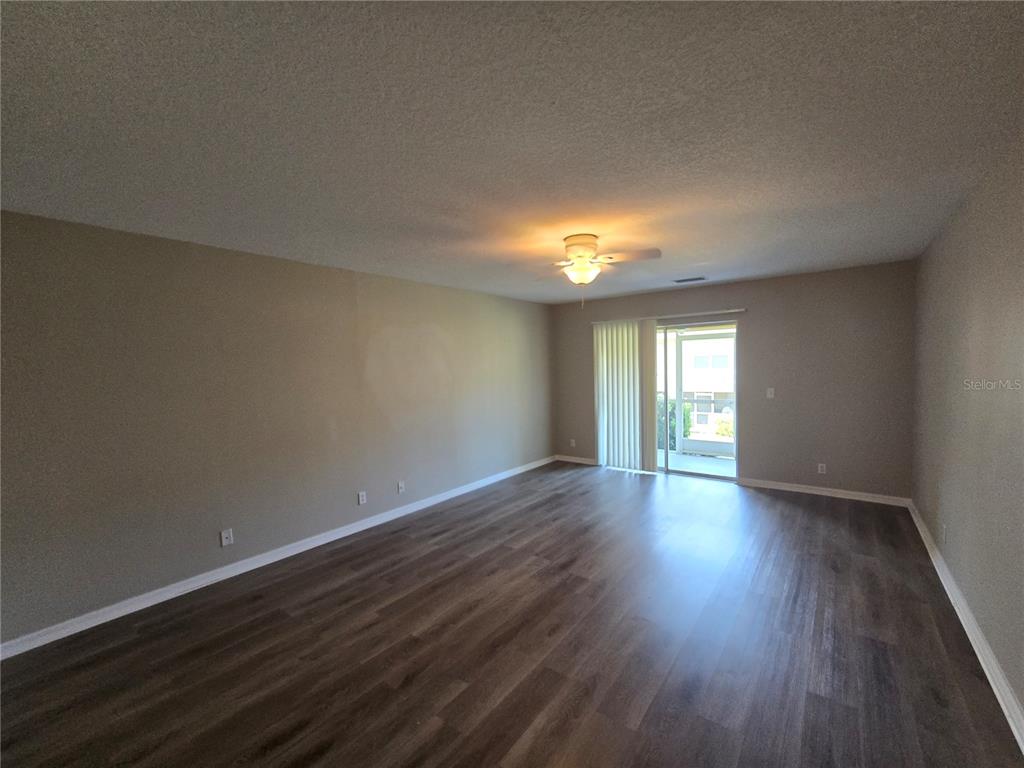 236 Castlekeeper Place Valrico, FL 33594 - Photo 4 of 14 a view of an empty room with wooden floor and window