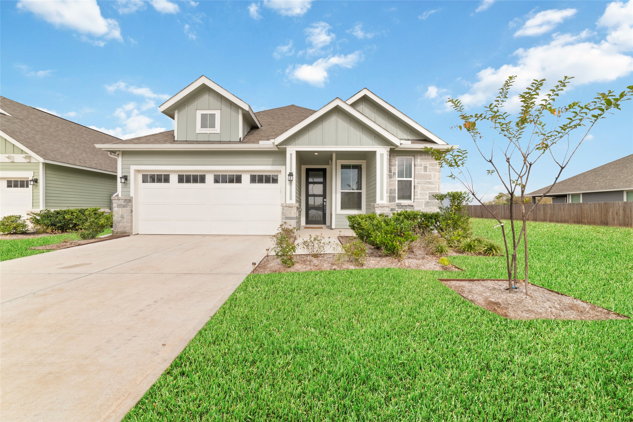 a front view of a house with a yard and trees