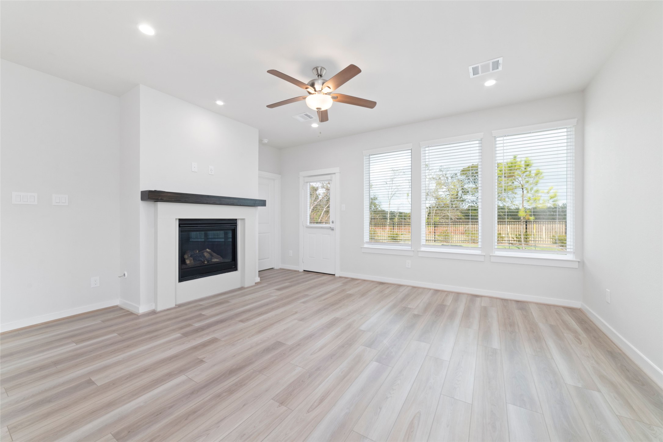 32906 School Hl Road Fulshear, TX 77441 - Photo 13 of 25 an empty room with windows fireplace and a sink