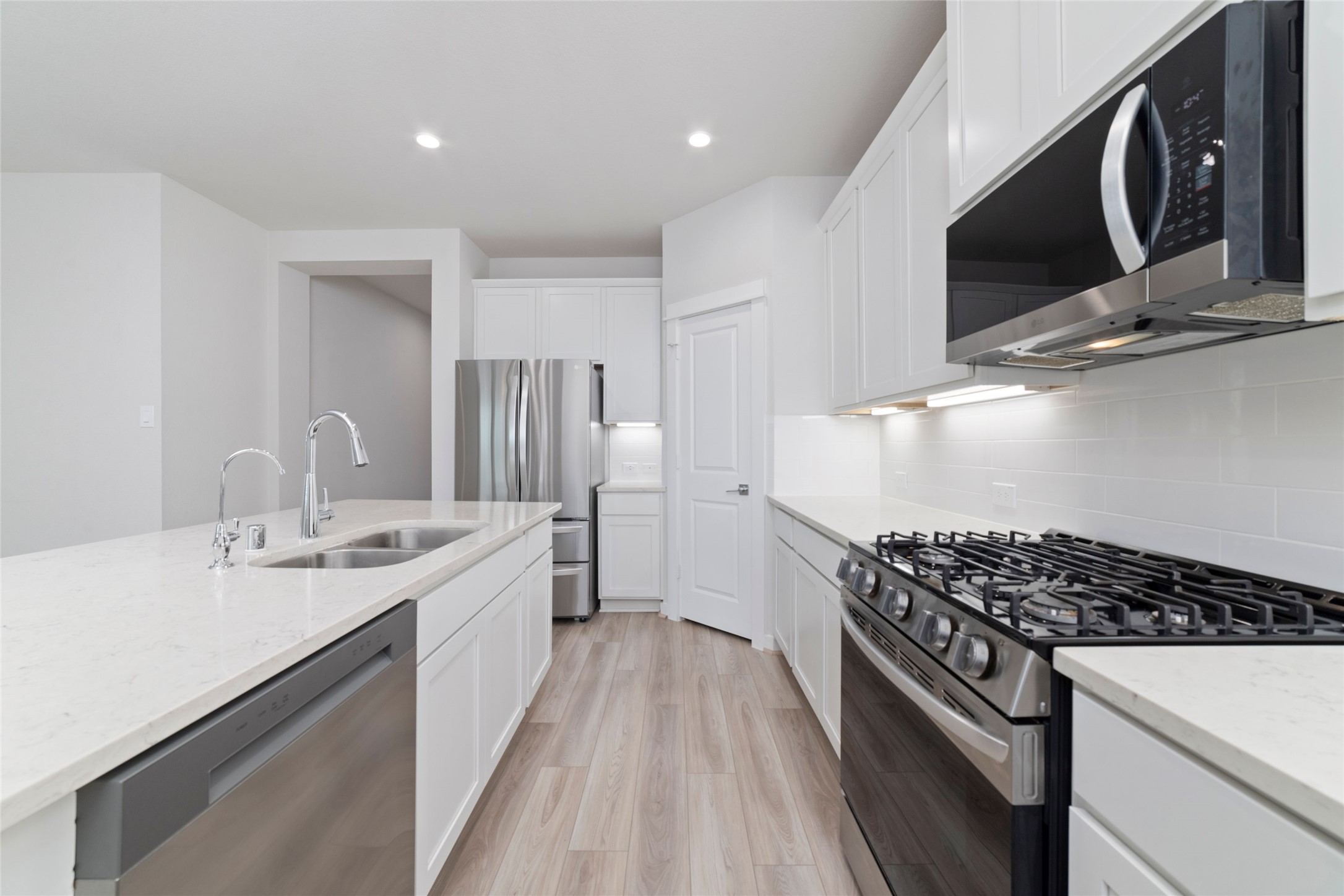 32906 School Hl Road Fulshear, TX 77441 - Photo 18 of 25 a kitchen with stainless steel appliances granite countertop a sink stove and cabinets
