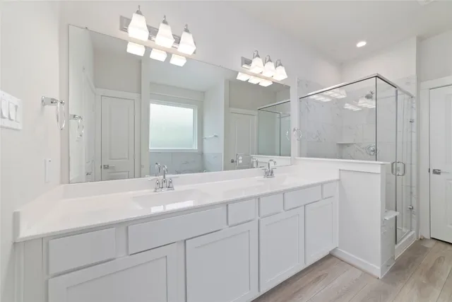 a bathroom with a double vanity sink mirror and