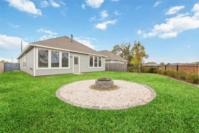 a view of a house with a backyard