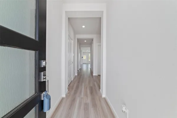 a view of a hallway with wooden floor and staircase