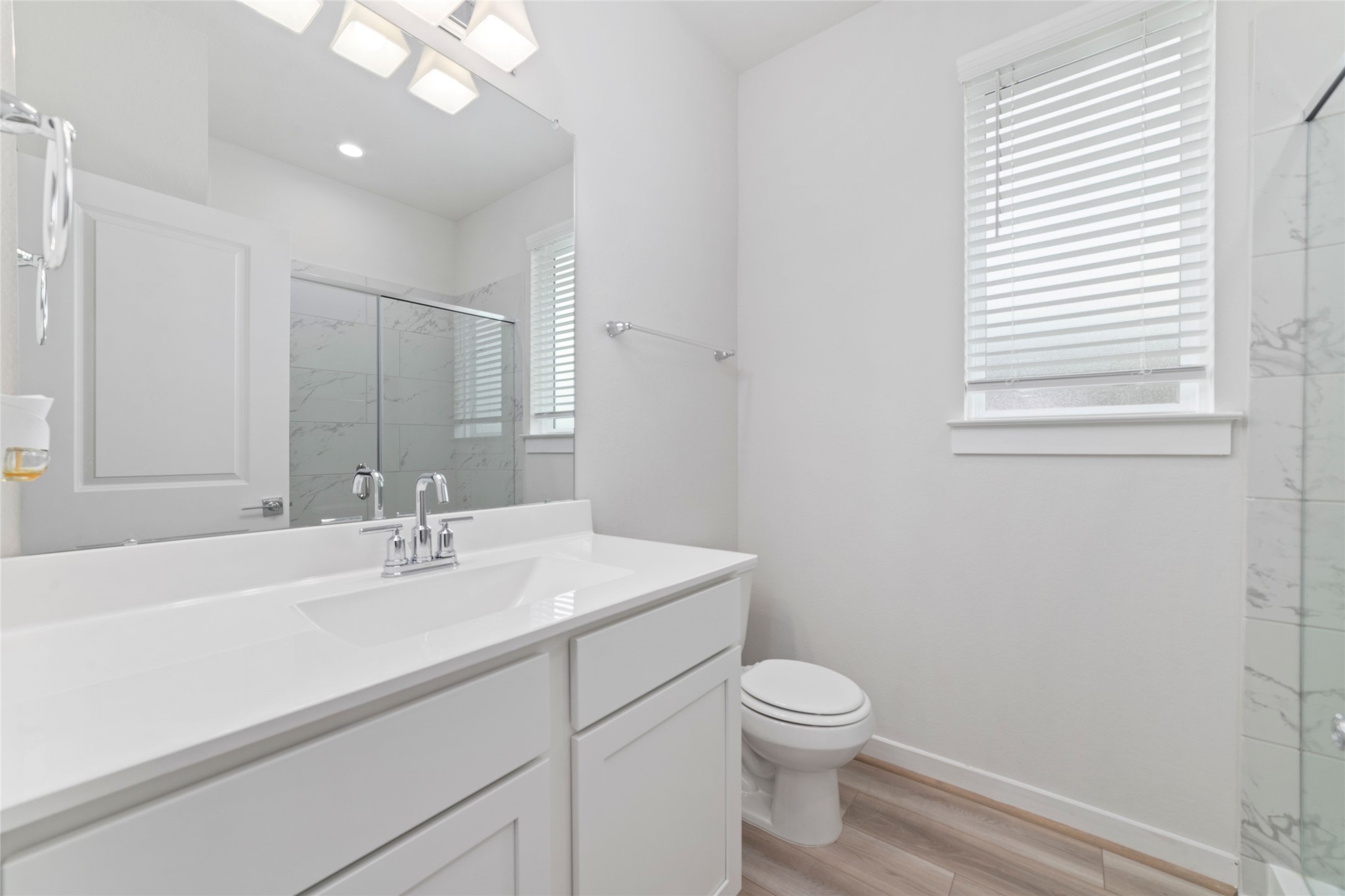 32906 School Hl Road Fulshear, TX 77441 - Photo 5 of 25 a bathroom with a sink a toilet and a mirror