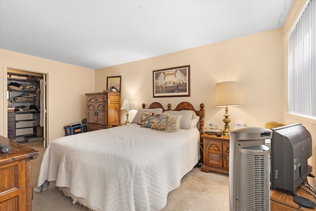 106 13th Street, Unit 114 Boston, MA 02129 - Photo 19 of 42 a bed room with a bed and a television