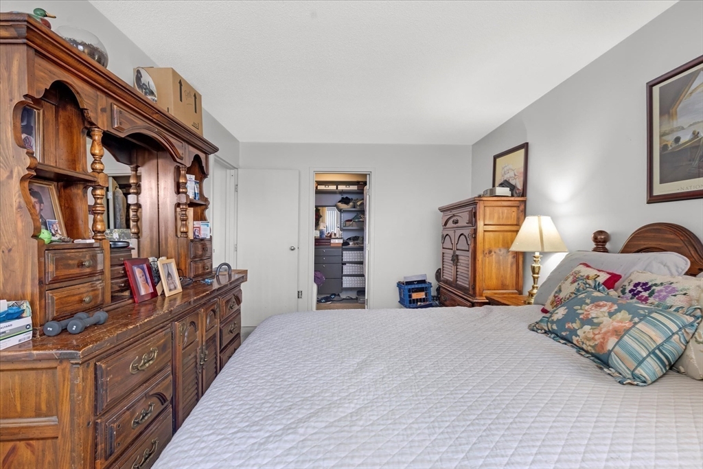 106 13th Street, Unit 114 Boston, MA 02129 - Photo 21 of 42 a bed room with a bed and a book shelf