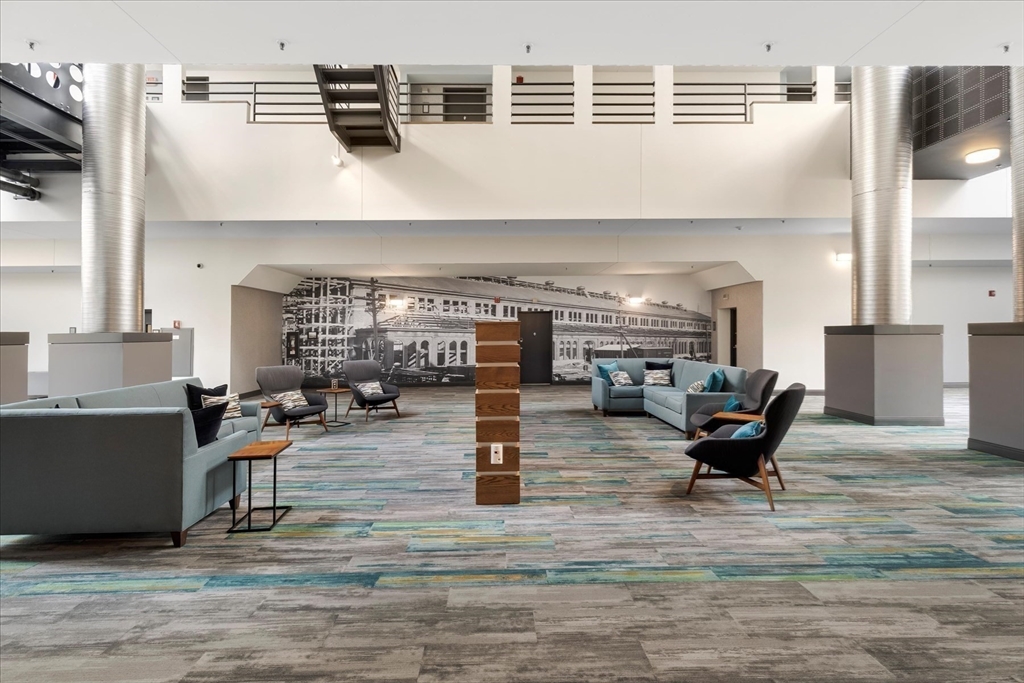 106 13th Street, Unit 114 Boston, MA 02129 - Photo 32 of 42 a living room with fireplace furniture and a wooden floor