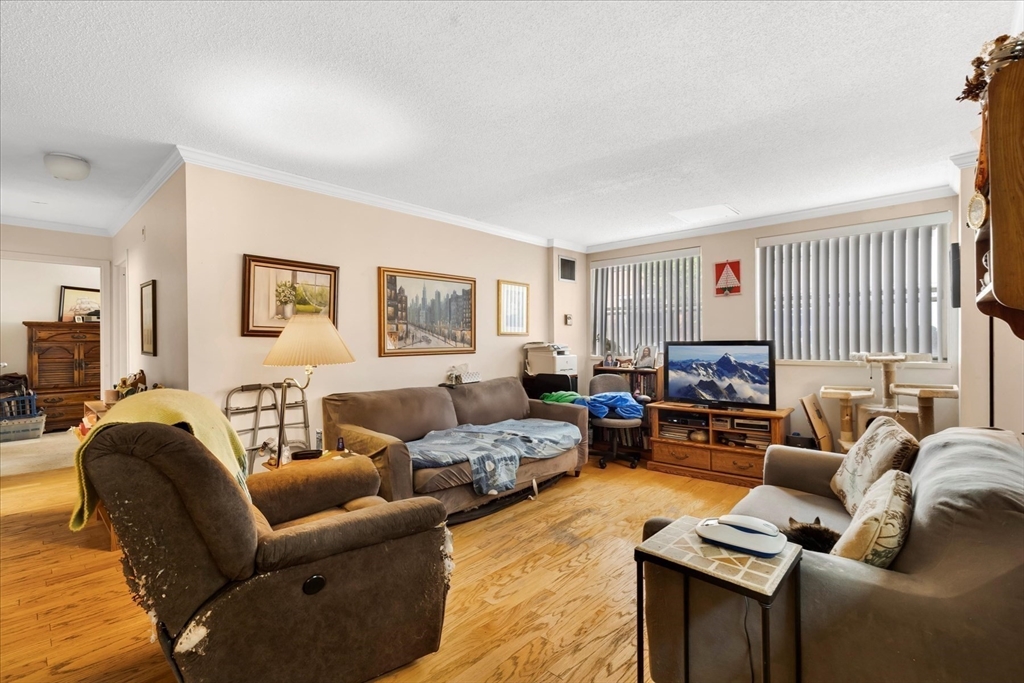 106 13th Street, Unit 114 Boston, MA 02129 - Photo 4 of 42 a living room with furniture or couch and a window