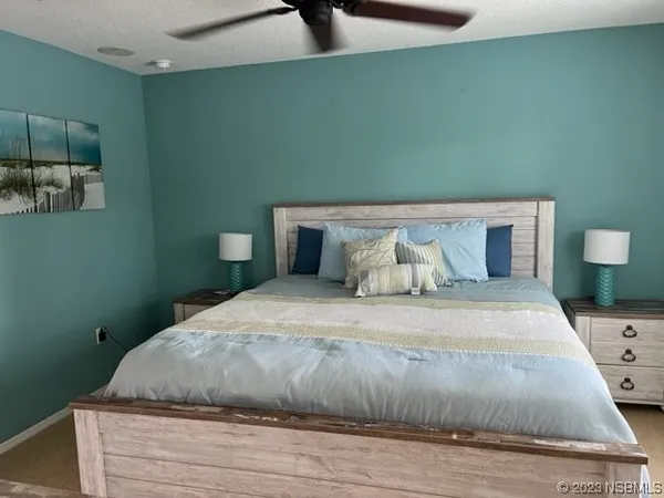 a bedroom with a bed and chair