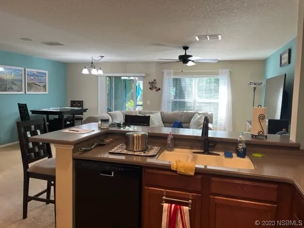 a kitchen with a table chairs stove and cabinets