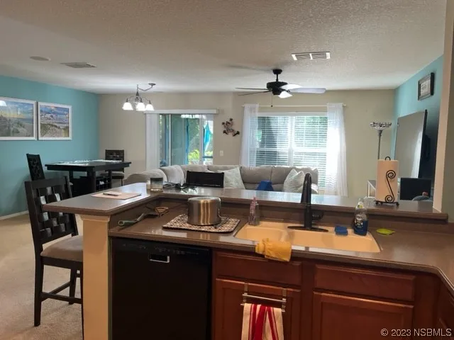 a kitchen with a table chairs stove and cabinets