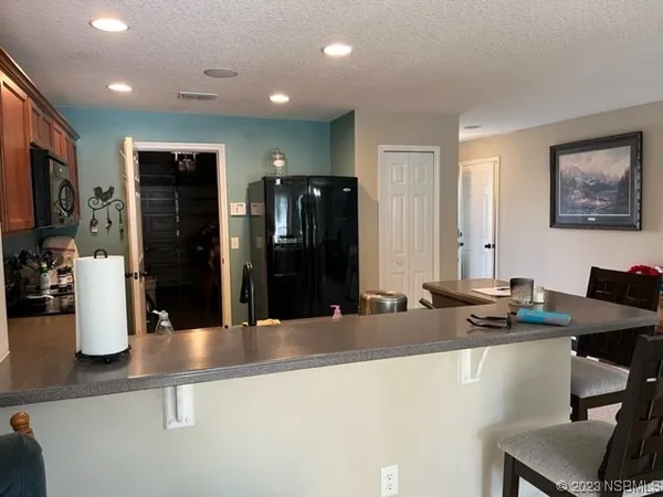 a kitchen with stainless steel appliances granite countertop a refrigerator and a sink
