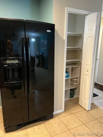 a view of a refrigerator in kitchen and a living room