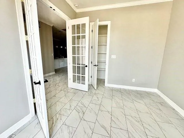 a view of a room with a hanging light and kitchen