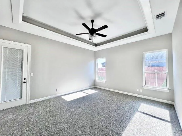 a large white bathroom with a large tub sink shower and mirror