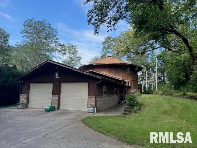 a house with green field in front of it