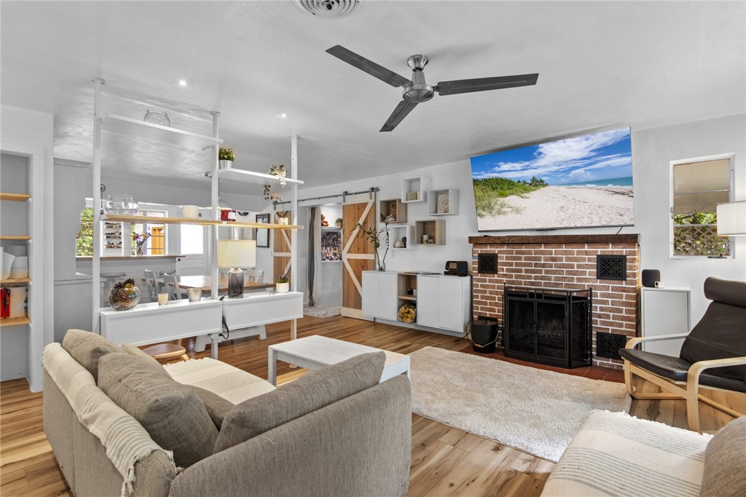 1908 37th Avenue Vero Beach, FL 32960 - Photo 12 of 34 a living room with furniture and a fireplace