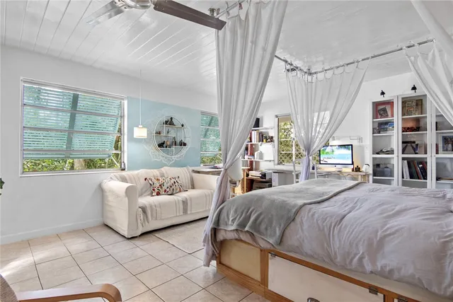 a bedroom with a large bed and a couch