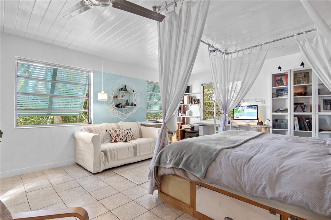 1908 37th Avenue Vero Beach, FL 32960 - Photo 14 of 34 a bedroom with a large bed and a couch