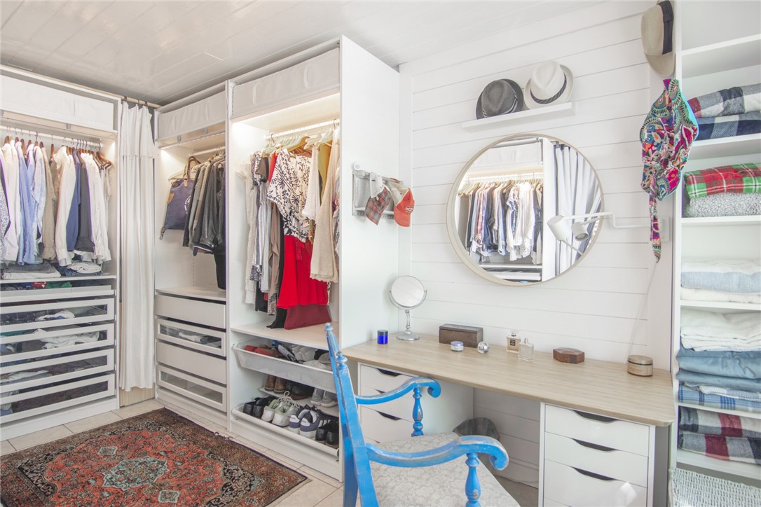 1908 37th Avenue Vero Beach, FL 32960 - Photo 19 of 34 a view of walk in closet with clothes and shoes