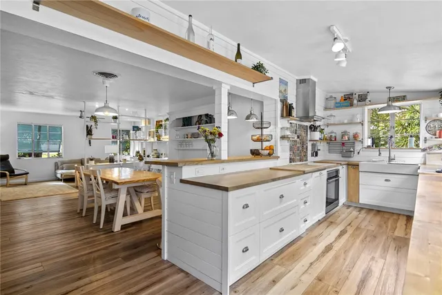 a kitchen with cabinets and wooden floor