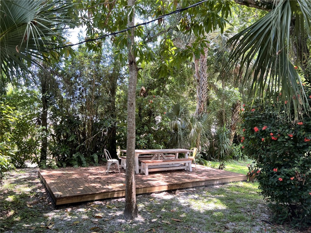 1908 37th Avenue Vero Beach, FL 32960 - Photo 31 of 34 a wooden bench sitting in the middle of a forest