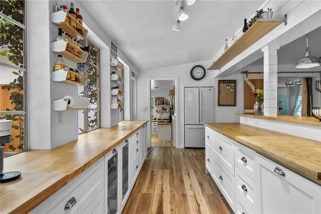 a spacious en suite bathroom with a granite countertop double vanity sink and a large mirror