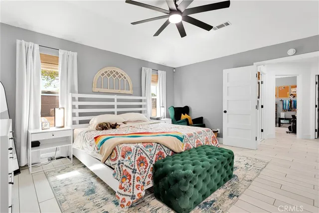 a view of a bedroom with wooden floor