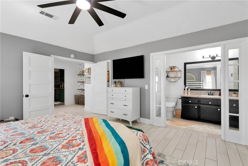 37077 Coyote Lake Road Newberry Springs, CA 92365 - Photo 26 of 58 a bedroom with furniture and a flat screen tv