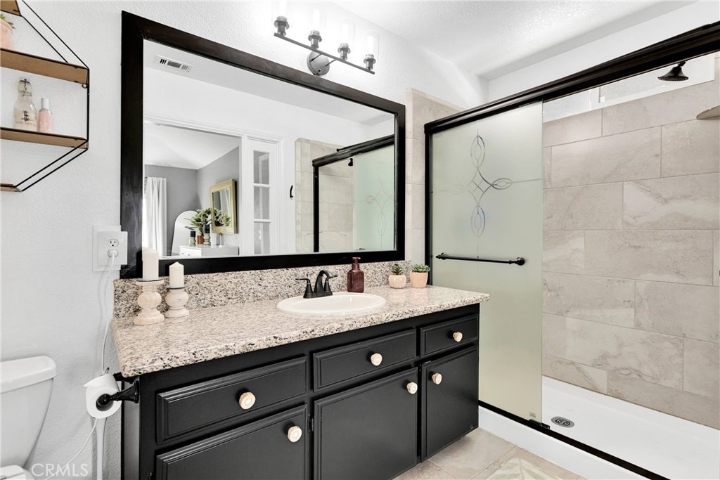37077 Coyote Lake Road Newberry Springs, CA 92365 - Photo 28 of 58 a bathroom with a granite countertop sink mirror and double