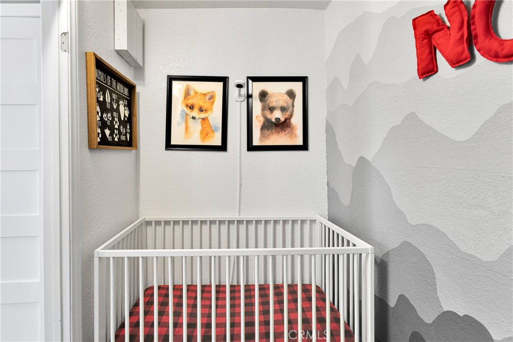 37077 Coyote Lake Road Newberry Springs, CA 92365 - Photo 30 of 58 a view of a bedroom with wooden floor