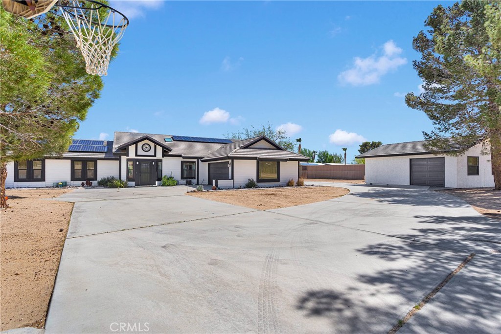 37077 Coyote Lake Road Newberry Springs, CA 92365 - Photo 3 of 58 a front view of a house with a yard and trees