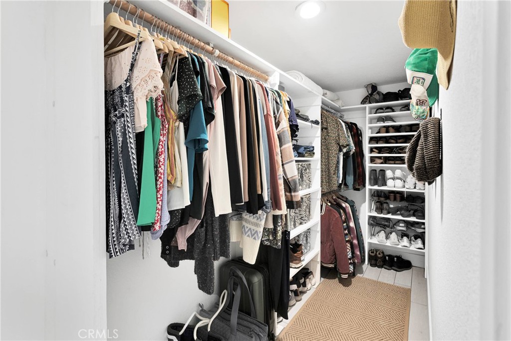 37077 Coyote Lake Road Newberry Springs, CA 92365 - Photo 31 of 58 a view of walk in closet with clothes and shoes