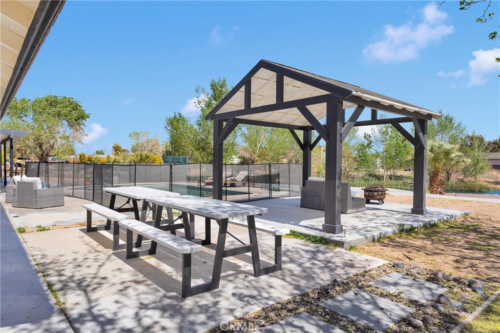 37077 Coyote Lake Road Newberry Springs, CA 92365 - Photo 35 of 58 a view of a chairs and tables in the patio