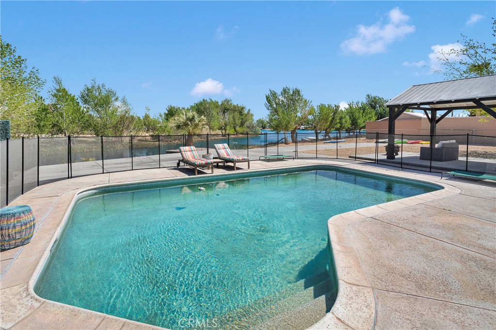 37077 Coyote Lake Road Newberry Springs, CA 92365 - Photo 40 of 58 a view of a swimming pool with a patio