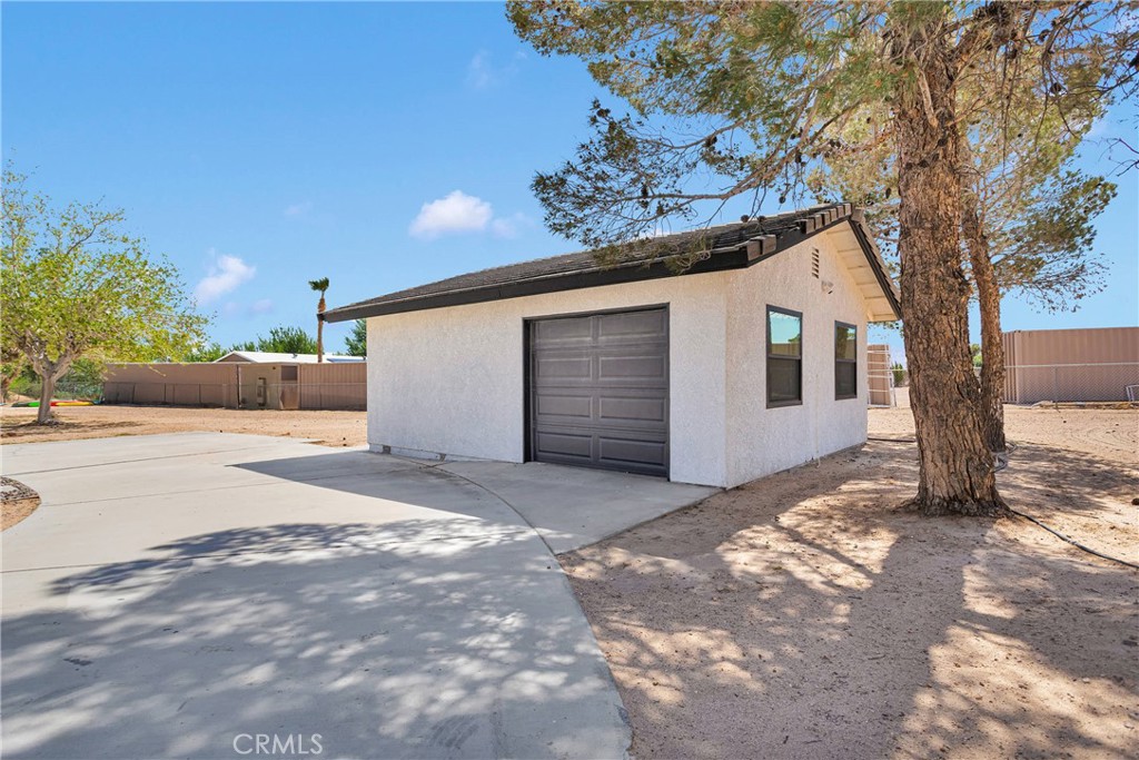 37077 Coyote Lake Road Newberry Springs, CA 92365 - Photo 47 of 58 a view of a house with a yard and garage